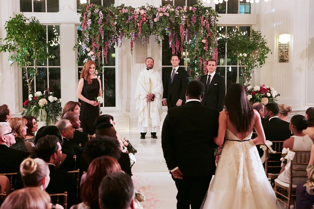 Meghan Markle in character as Rachel Zane walking down the aisle
